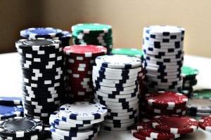 Stacked poker chips of various colors; image by Amanda Jones, via Unsplash.com. 
