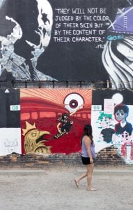 Quote from Martin Luther King, Jr. painted on side of building: &ldquo;They will not be judged by the color of their skin but by the content of their character.&rdquo; Image by Allie Smith, via Unsplash.com.