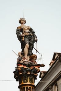Statue of Lady Justice; image by Joel & Jasmin F&oslash;restbird, via Unsplash.com.