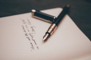 Fountain pen on stationery; image by &Aacute;lvaro Serrano, via Unsplash.com.
