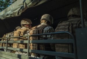 Soldiers in truck; image by Diego Gonz&aacute;lez, via Unsplash.com.