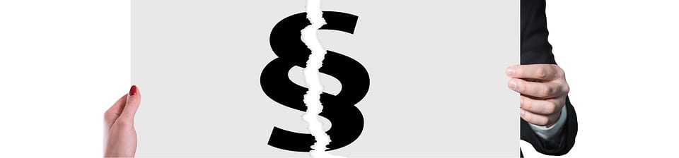 Sign with legal symbol for &ldquo;section&rdquo; torn in two, man holding one half, woman holding the other; image by Geralt, via Pixabay.com.