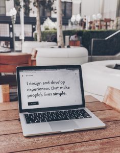 Laptop with screen saying, &ldquo;I design and develop experiences that make people&rsquo;s lives simple.&rdquo; Image by Ben Kolde, via Unsplash.com.