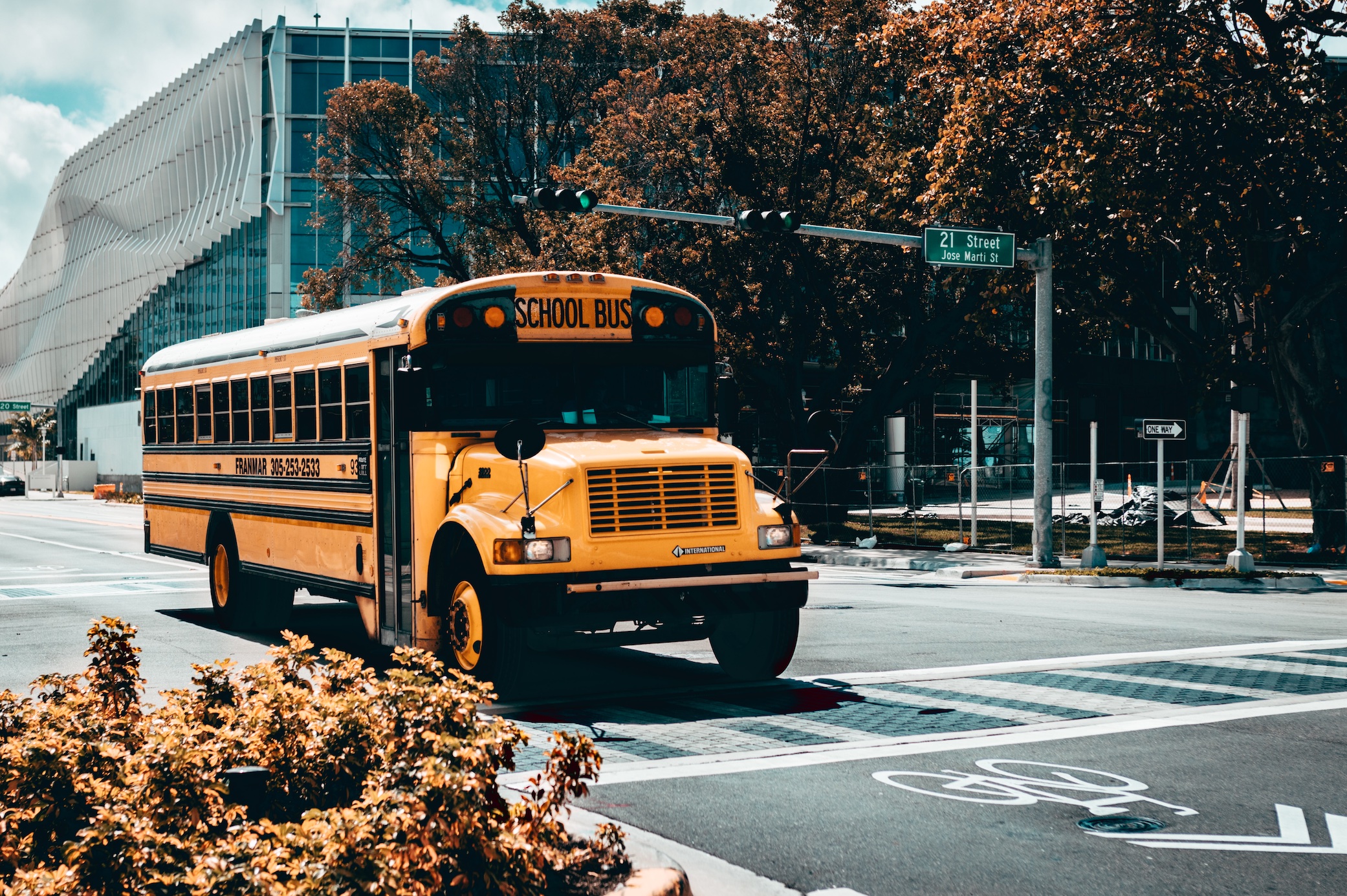School bus stopped at intersection; image by Marcelo Cidrack, via Unsplash.com.