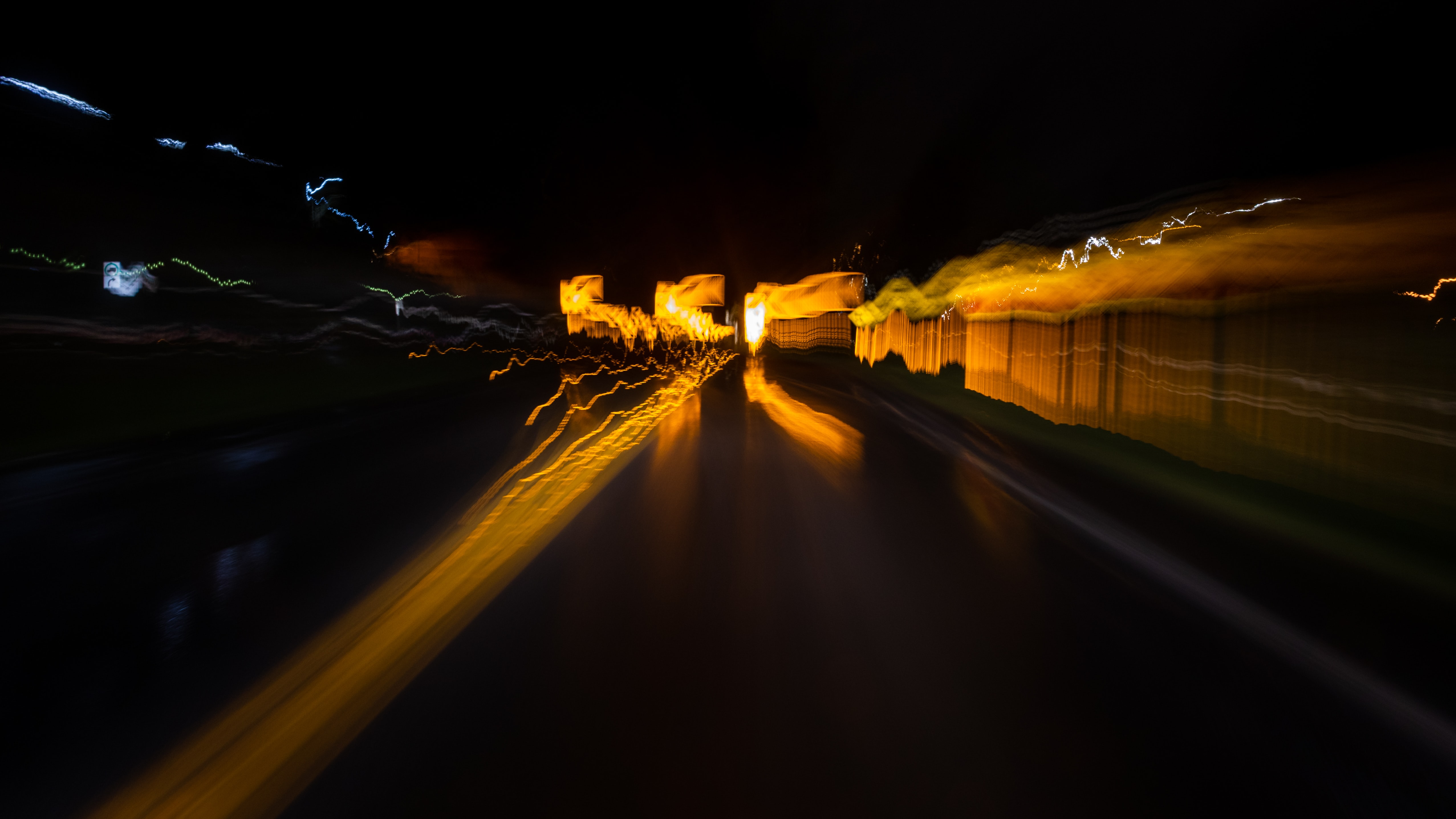Blurry motion image of street; image by Greg Rosenke, via Unsplash.com.