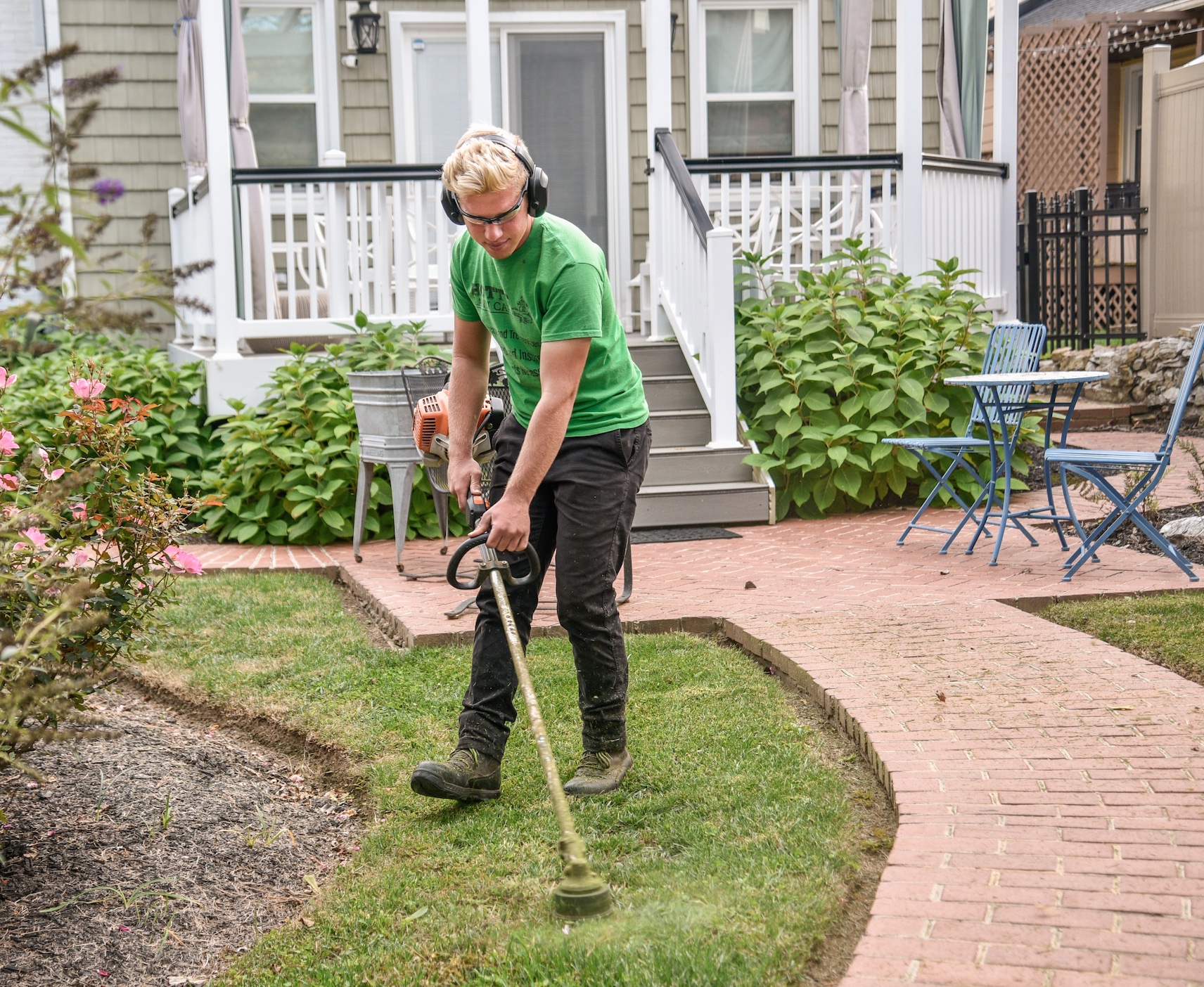 Man using weed whacker; image by Jared Muller, via Unsplash.com.