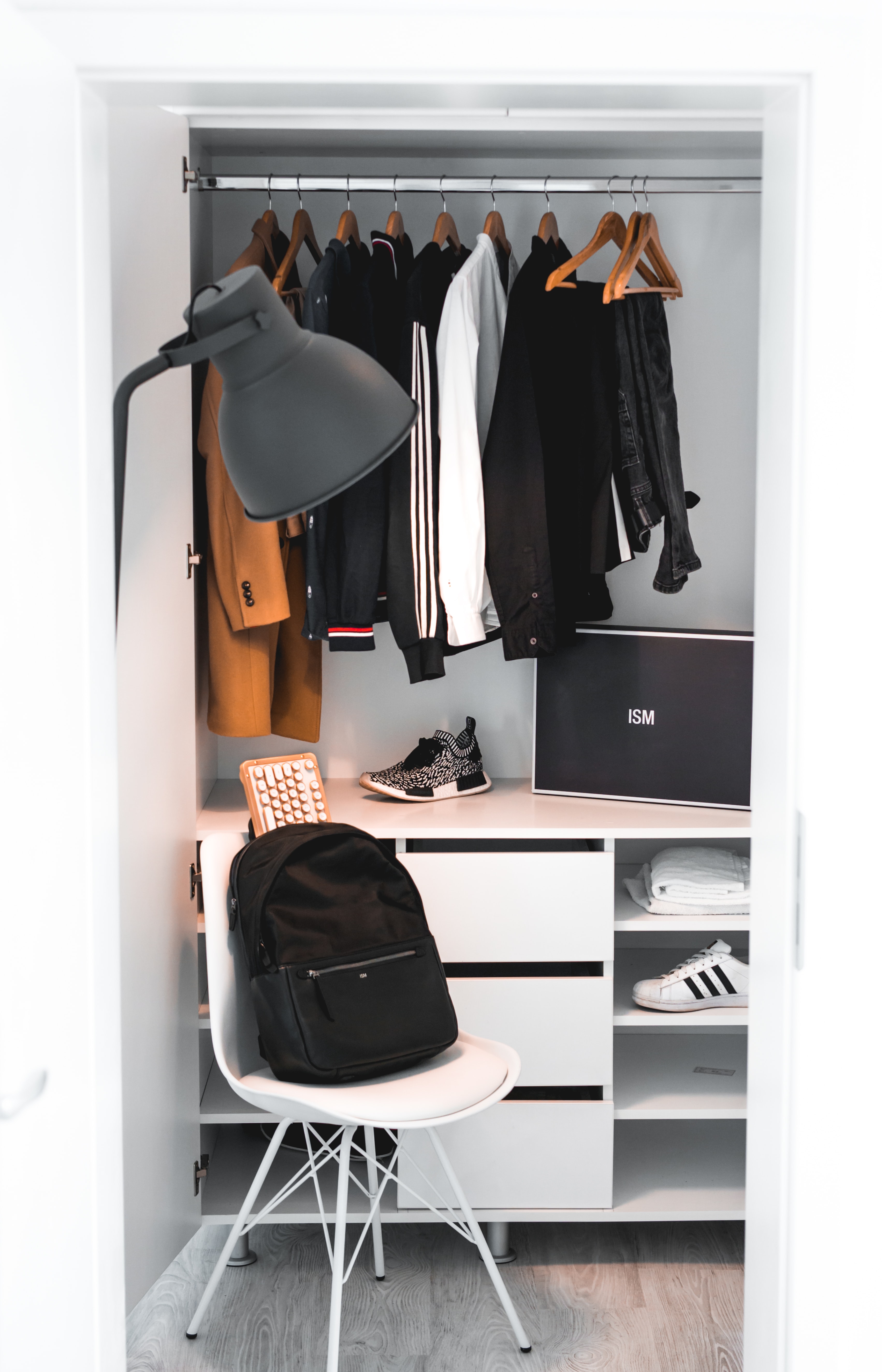 Backpack on chair near cubby closet; image by Alexandru Acea, via Unsplash.com.