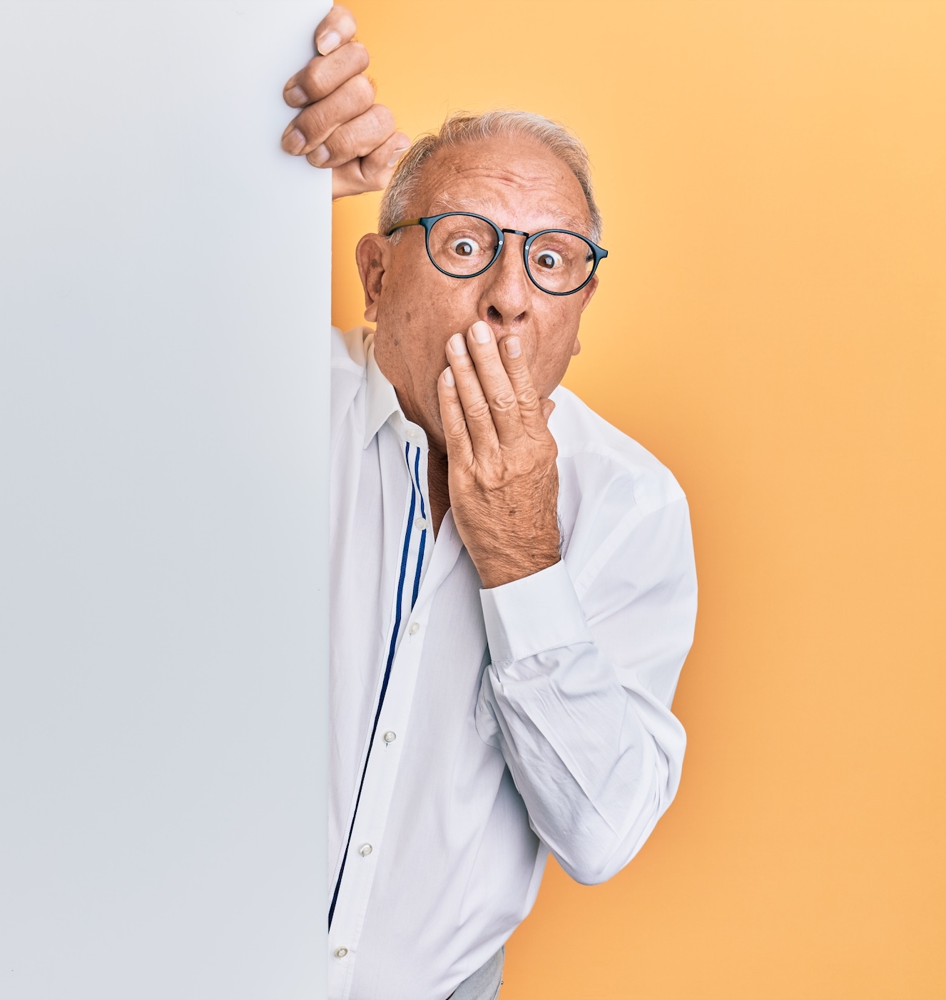 Man in white dress shirt with hand over mouth; image by KrakenImages, via Unsplash.com.