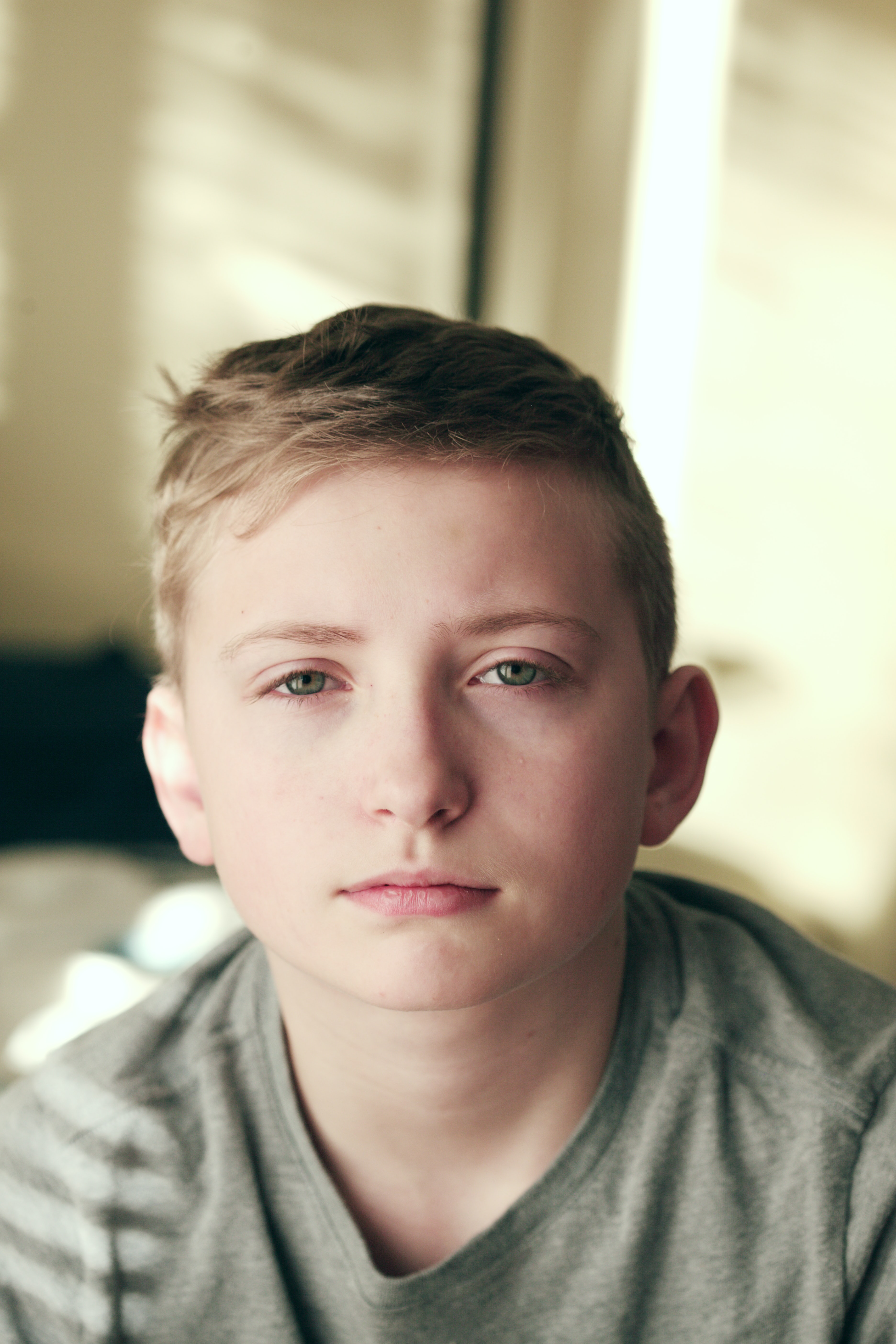 Teen boy in crew neck shirt looking at camera; image by Alexander Grey, via Unsplash.com.