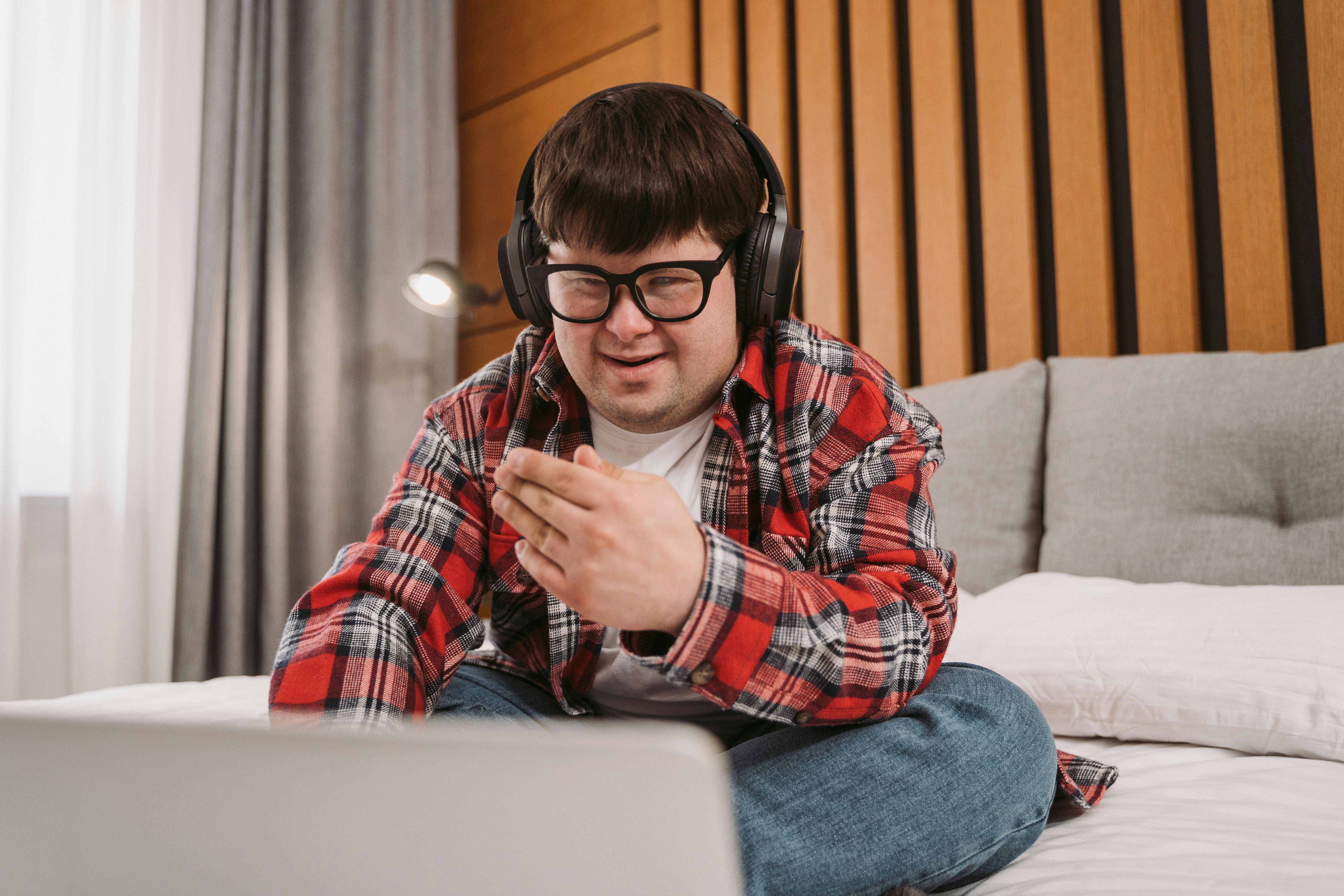 Man with Down Syndrome using laptop; image by Mart Production, via Pexels.com.